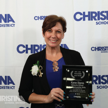 Photo of Karen Dipres Teacher of the Year Networks School for Employability Skills with award